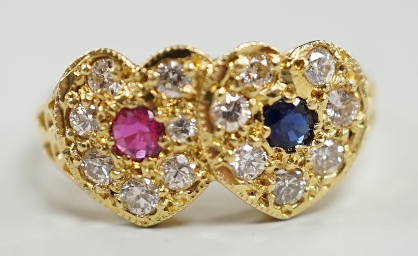 A modern 18ct gold, ruby, sapphire and diamond set twin heart cluster ring, size M, gross weight 4 grams.